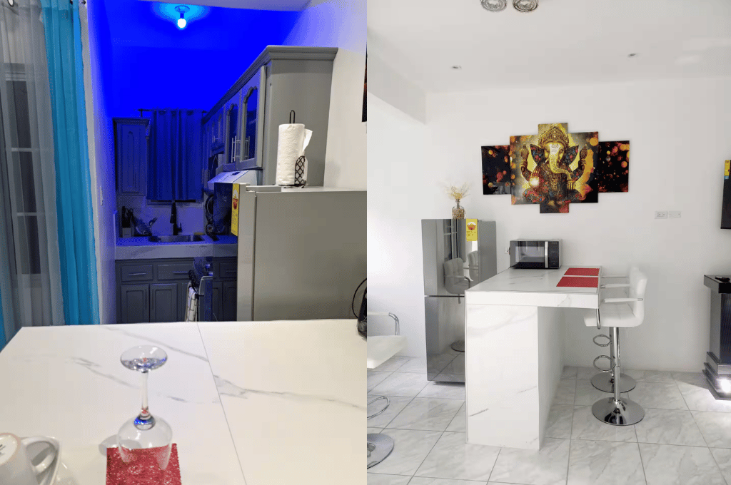 Serenity Vibes apartment open kitchen and dining area featuring modern cabinets, appliances, and contemporary lighting