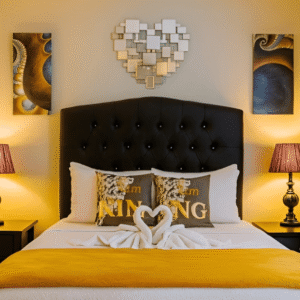 Cozy bedroom with queen bed, decorative pillows, and warm lighting at Mountain Echo Suites Montego Bay