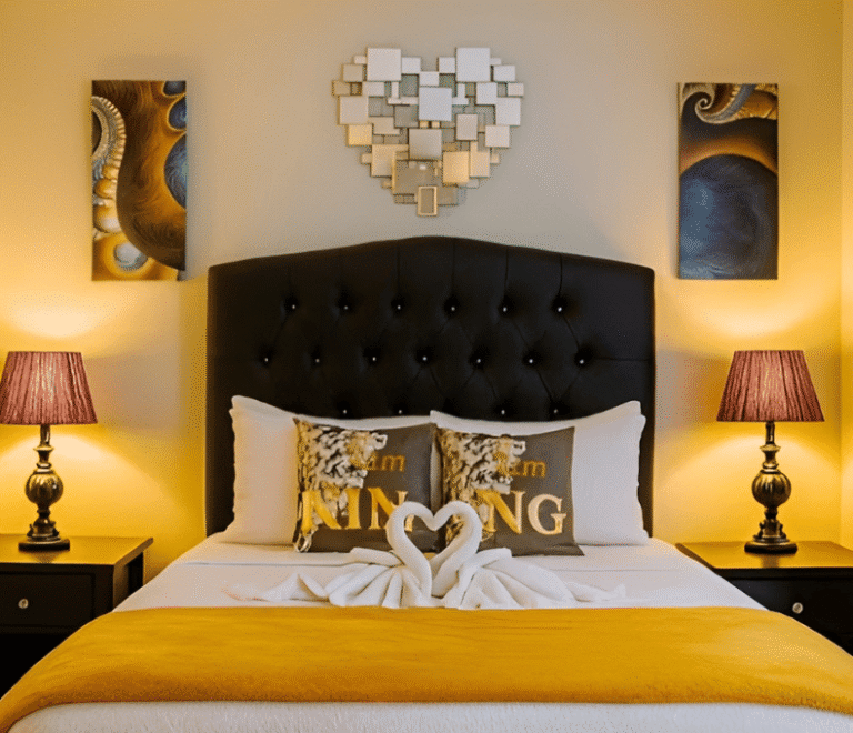Cozy bedroom with queen bed, decorative pillows, and warm lighting at Mountain Echo Suites Montego Bay
