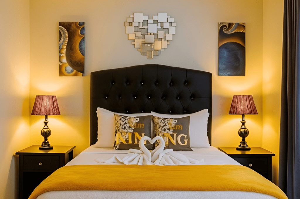 Cozy bedroom with queen bed, decorative pillows, and warm lighting at Mountain Echo Suites Montego Bay