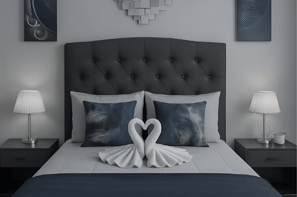 Beautiful Serenity View bedroom featuring swan towel décor on a modern tufted bed