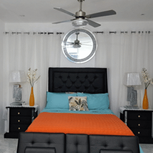 Spacious master bedroom in Serenity Haven Suite featuring turquoise accents and a tufted headboard