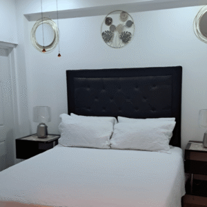 Modern bedroom at Serenity Whisper Retreat with white décor and queen bed