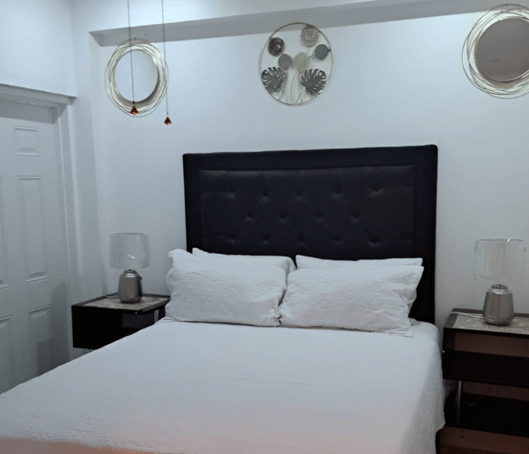 Modern bedroom at Serenity Whisper Retreat with white décor and queen bed